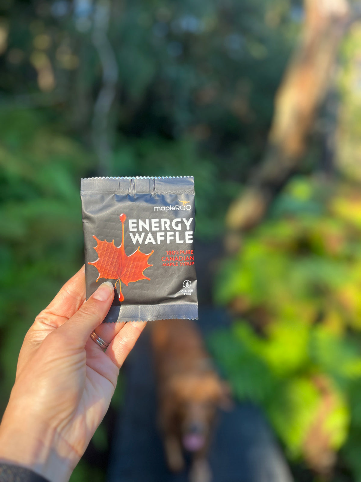 Maple Leaf Energy Waffle packet from mapleROO with a blurred outdoor background